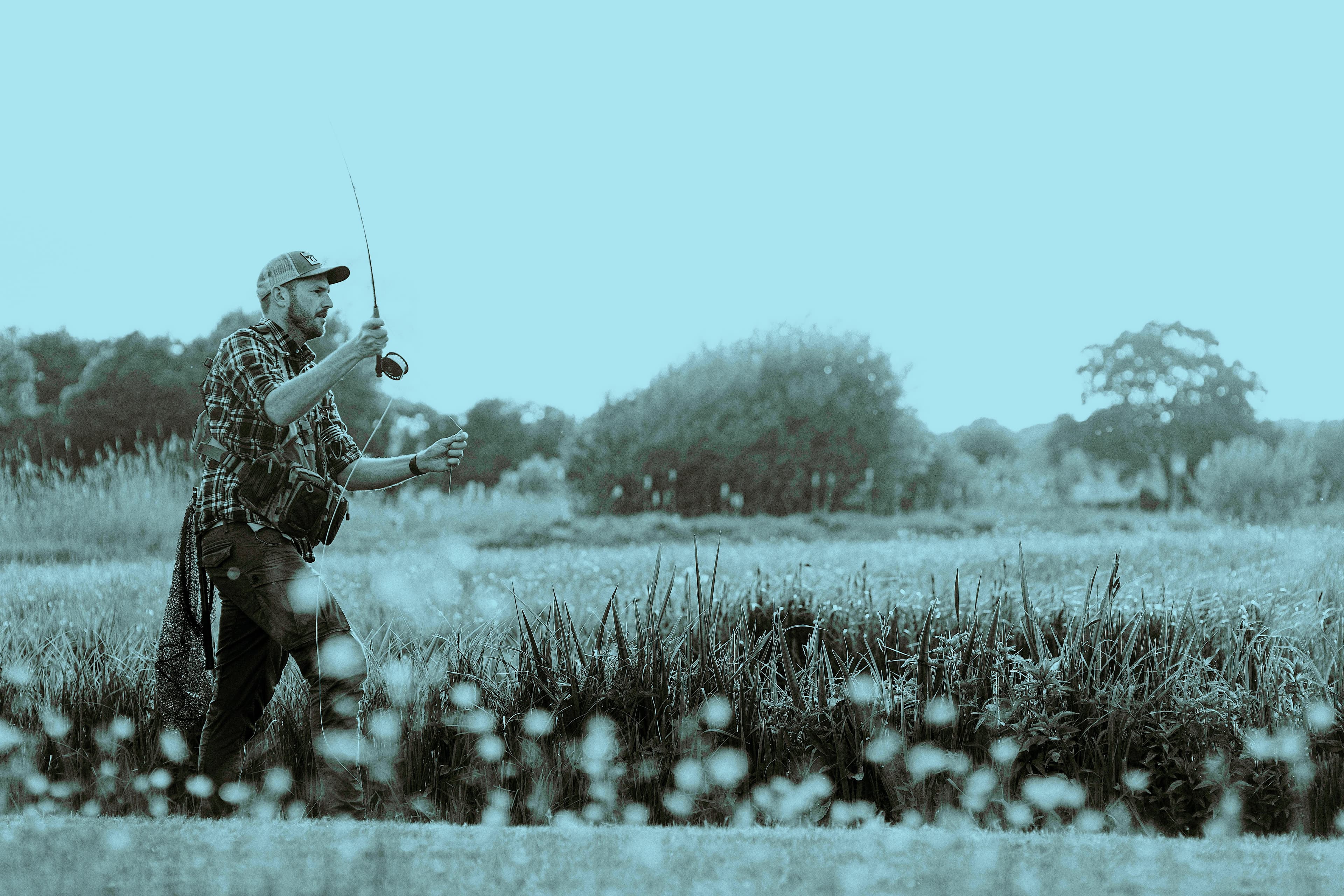 Angler casting on an English chalk stream