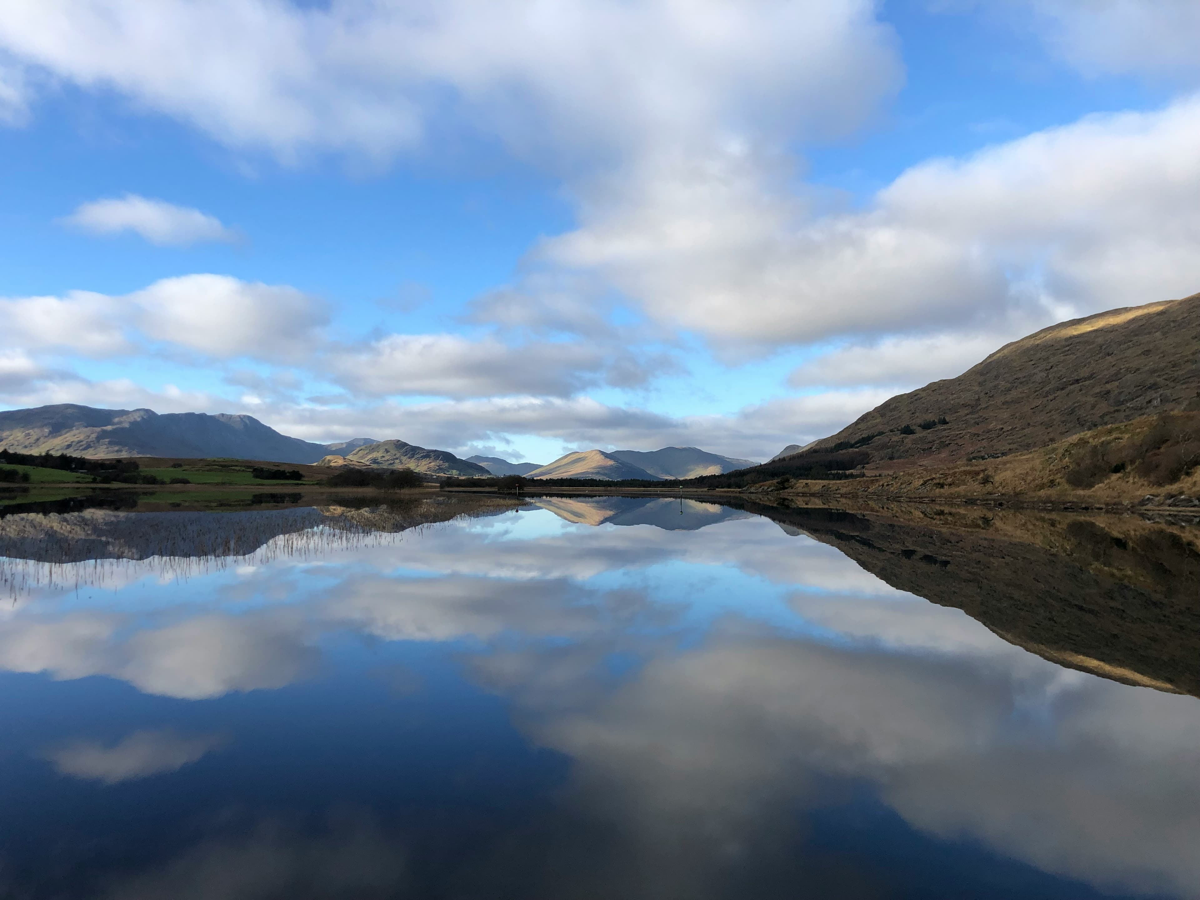 Lough Corrib — still water reflecting the mountains