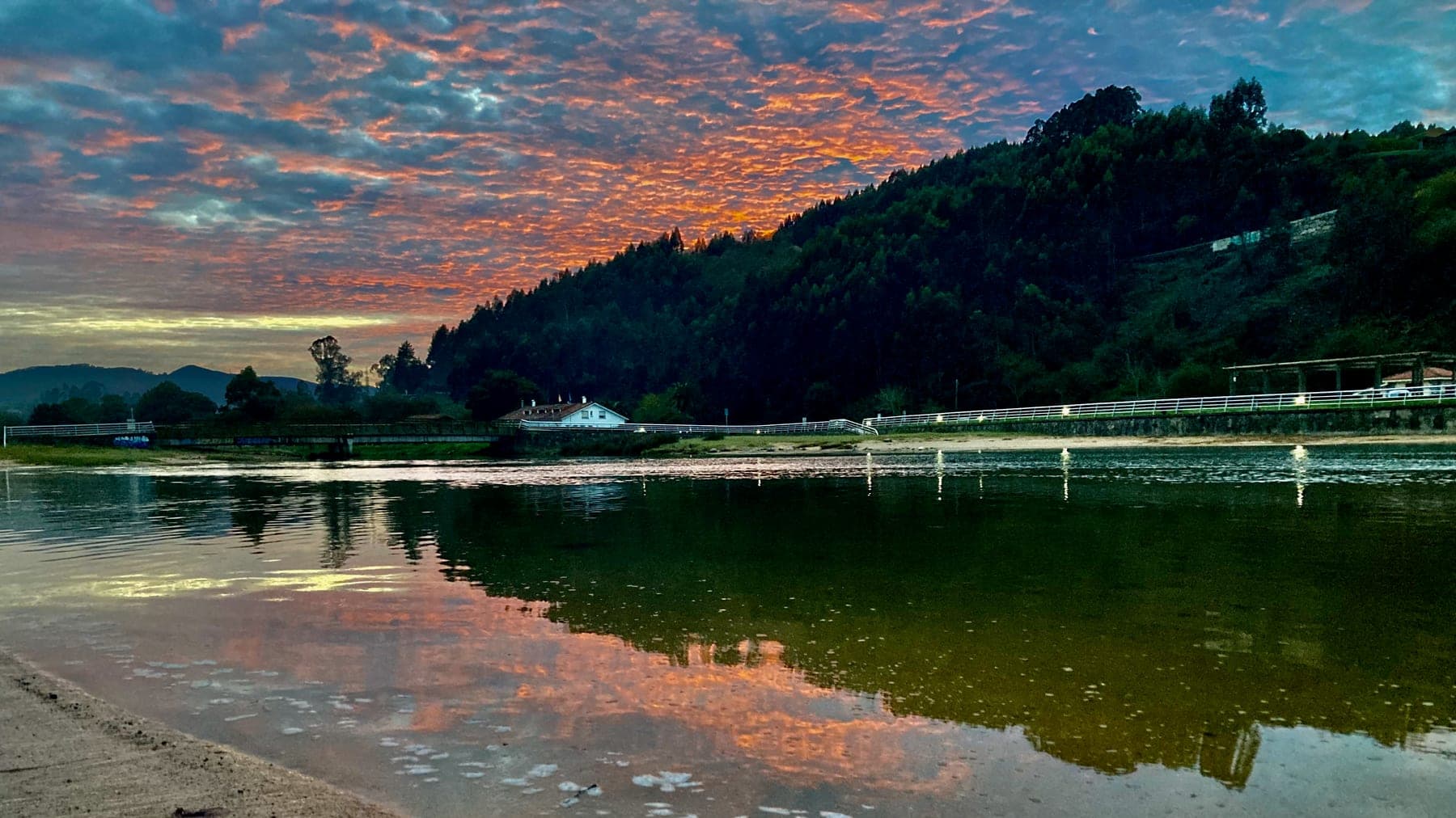 Asturian estuary at sunset — tidal water where mullet gather on the drop